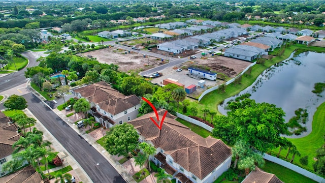 drone / aerial view with a water view and a residential view