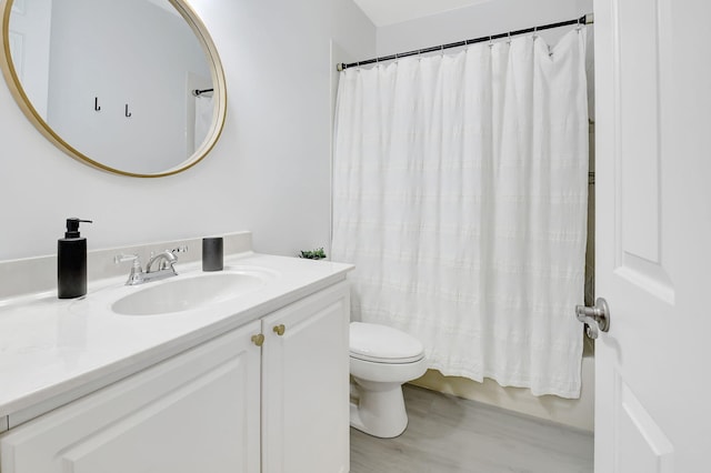 full bathroom featuring shower / bathtub combination with curtain, vanity, toilet, and wood finished floors