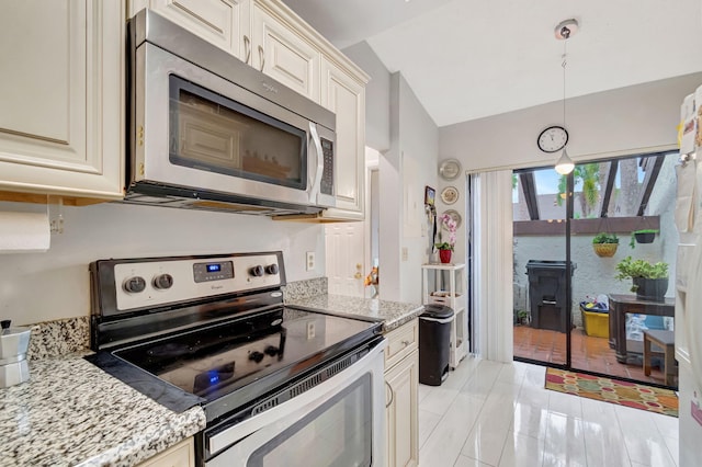 kitchen featuring lofted ceiling, light stone countertops, appliances with stainless steel finishes, and pendant lighting