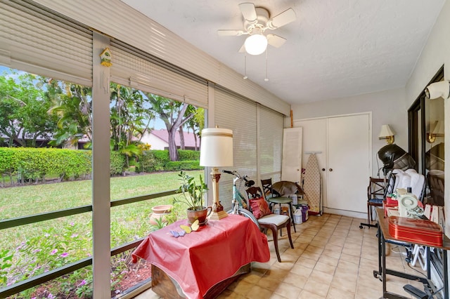 sunroom featuring a ceiling fan