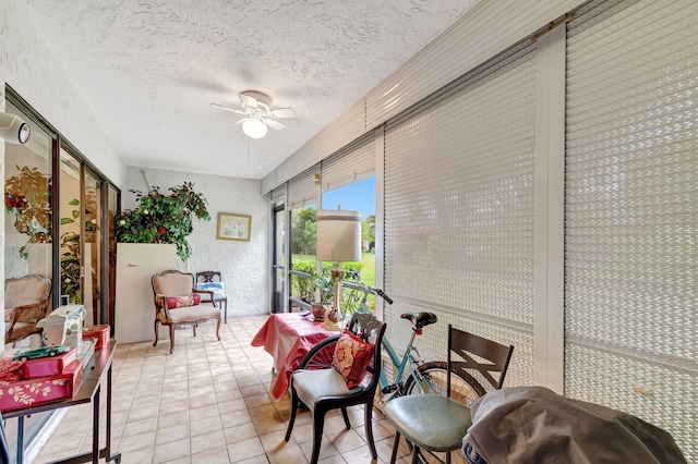 sunroom featuring a ceiling fan