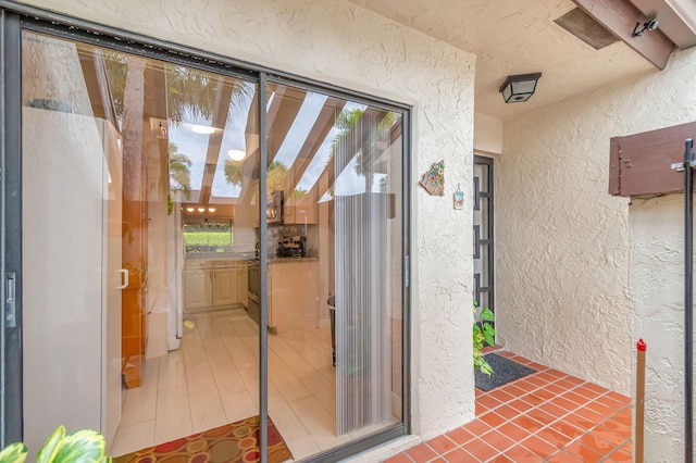 doorway to property featuring stucco siding