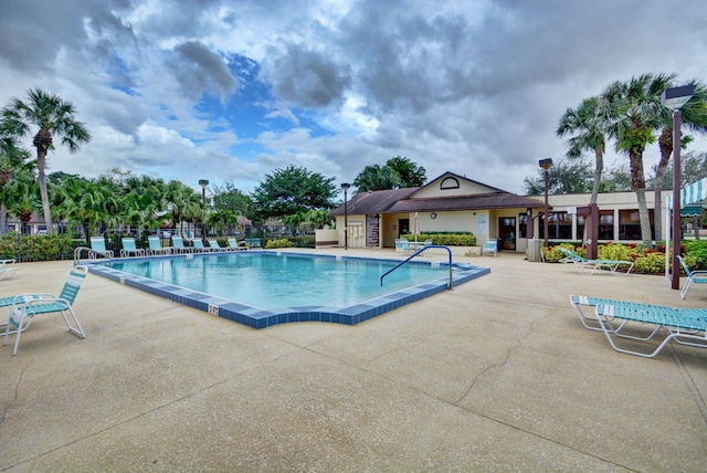 pool with fence and a patio