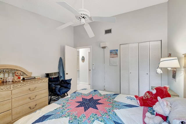 bedroom featuring high vaulted ceiling, a closet, visible vents, and ceiling fan