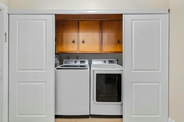 laundry room featuring cabinet space and washer and clothes dryer