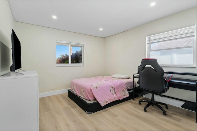 bedroom with light wood-style floors, baseboards, and recessed lighting