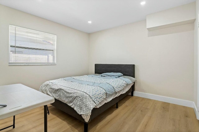 bedroom with recessed lighting, baseboards, and light wood finished floors