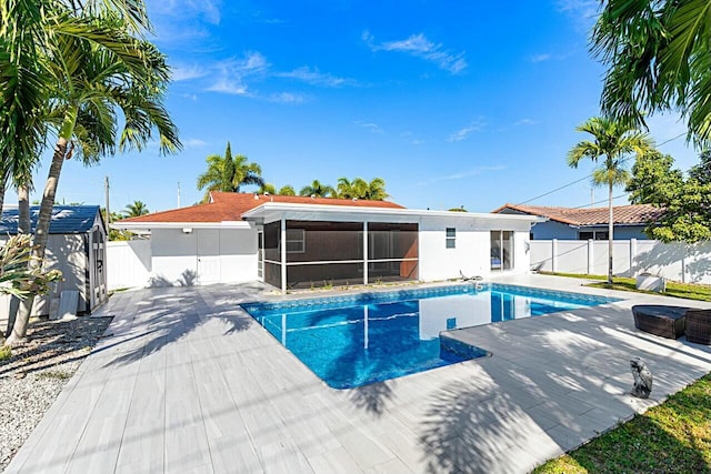 view of pool with a fenced in pool, a patio area, a sunroom, and a fenced backyard