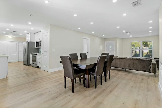 dining space featuring baseboards, light wood finished floors, visible vents, and recessed lighting