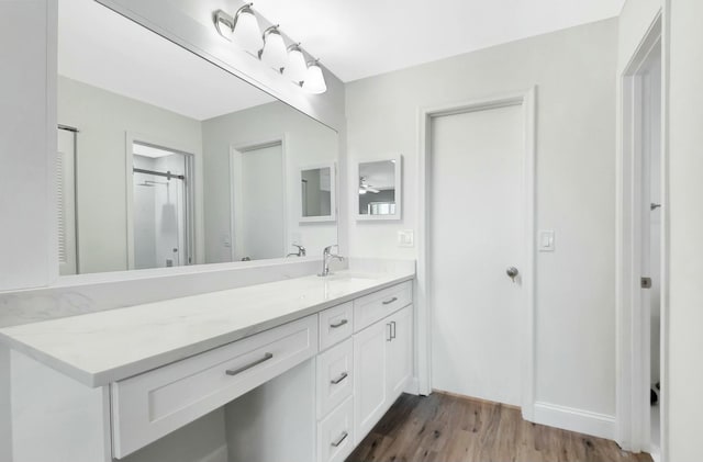 bathroom featuring wood finished floors and vanity