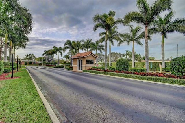 view of road featuring curbs and a gated entry