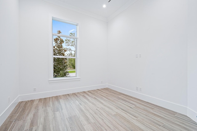 unfurnished room featuring crown molding, light wood finished floors, recessed lighting, and baseboards