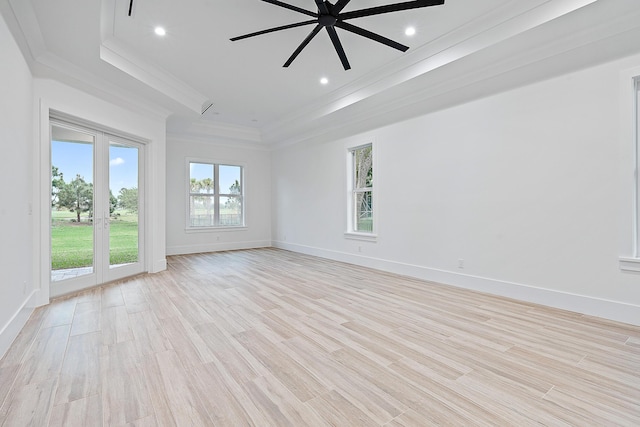 spare room with crown molding, recessed lighting, a ceiling fan, light wood-type flooring, and baseboards