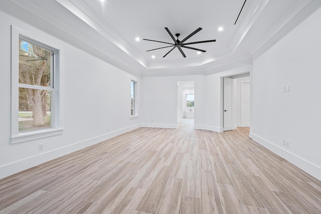 unfurnished room featuring light wood finished floors, a tray ceiling, ornamental molding, and recessed lighting