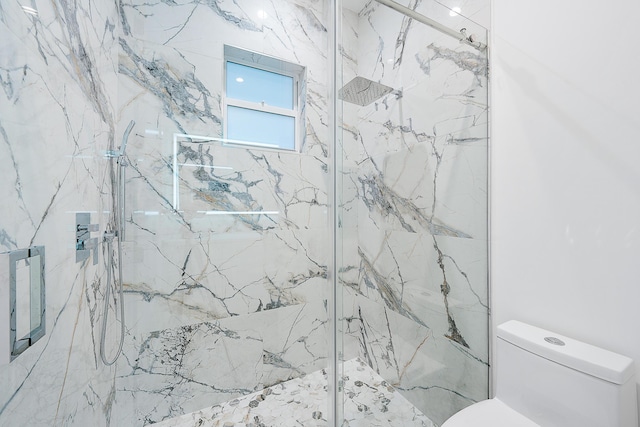 full bath with a marble finish shower and toilet