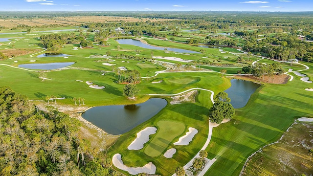 bird's eye view with a water view and golf course view