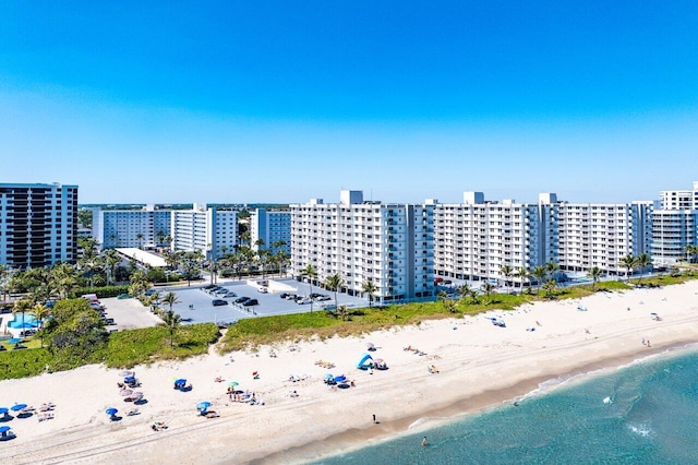 bird's eye view with a city view, a view of the beach, and a water view