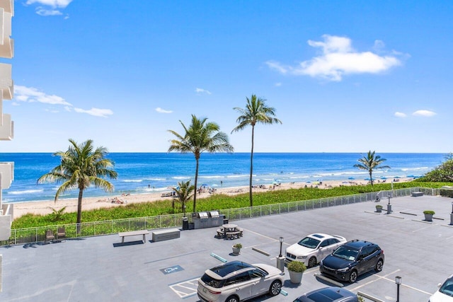 water view featuring a view of the beach and fence