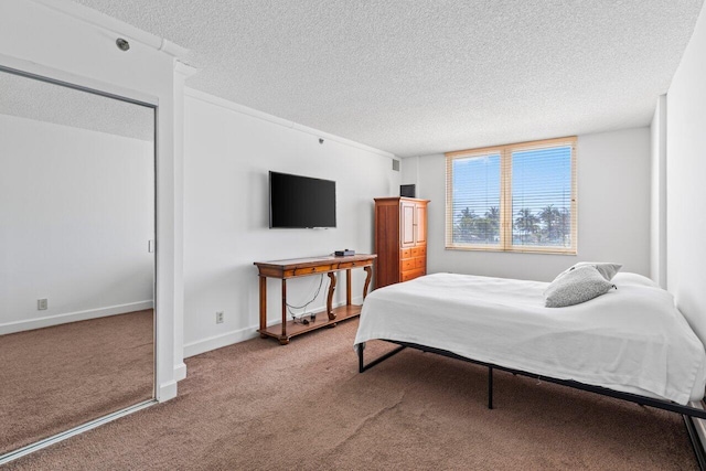 bedroom featuring carpet flooring, a textured ceiling, and baseboards
