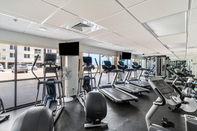 workout area with a drop ceiling and visible vents