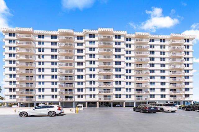 view of property featuring uncovered parking