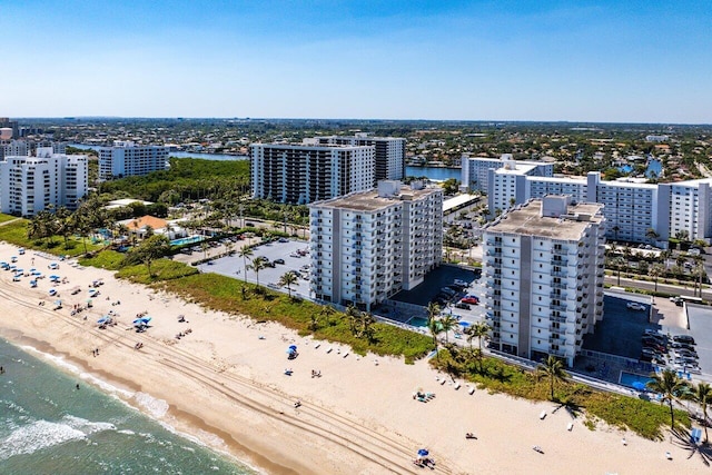 aerial view featuring a city view, a beach view, and a water view