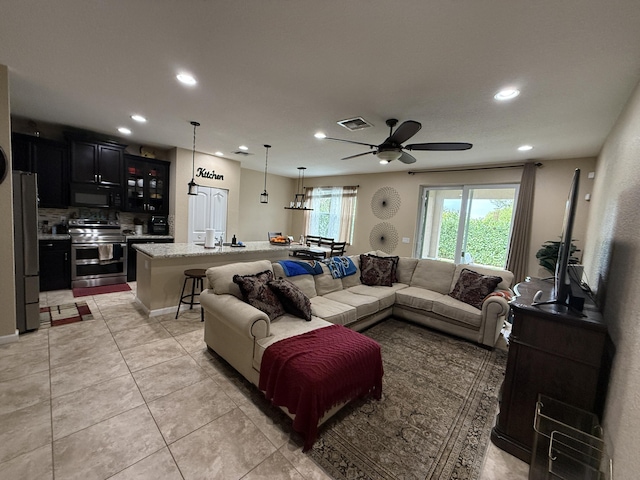 living area with recessed lighting, visible vents, ceiling fan, and light tile patterned flooring