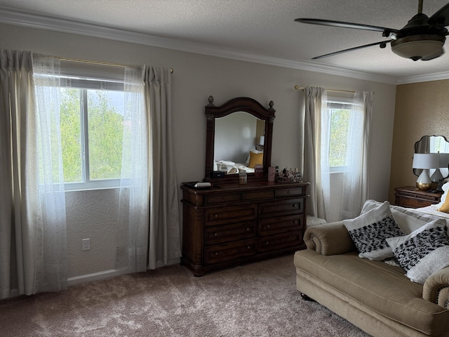 bedroom featuring carpet floors, crown molding, a textured ceiling, and a ceiling fan