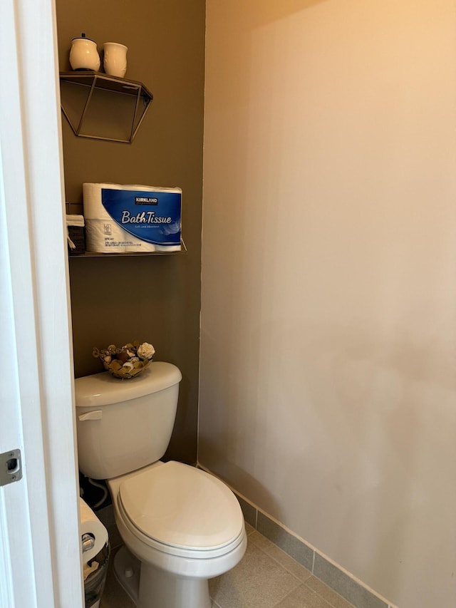 bathroom with toilet and baseboards