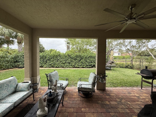 view of patio with a fenced backyard, outdoor lounge area, and a ceiling fan