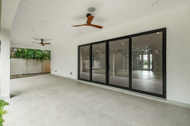 view of patio featuring ceiling fan and fence