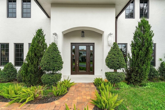 doorway to property with french doors and stucco siding