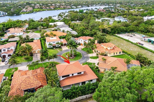 drone / aerial view with a residential view and a water view