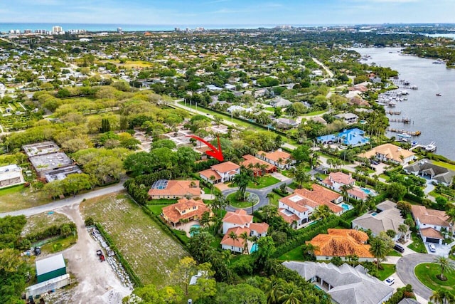 birds eye view of property with a residential view and a water view