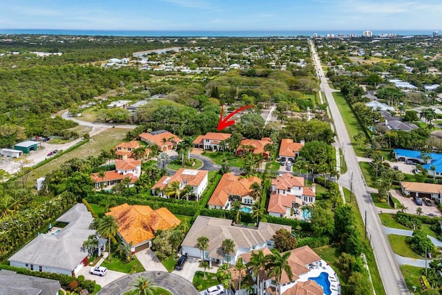 bird's eye view with a residential view and a water view