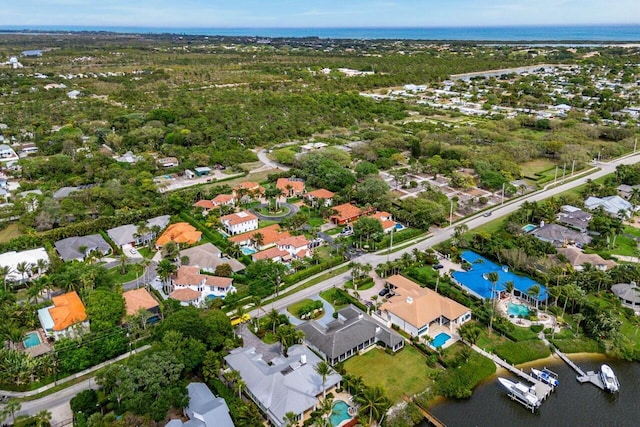 birds eye view of property featuring a water view and a residential view