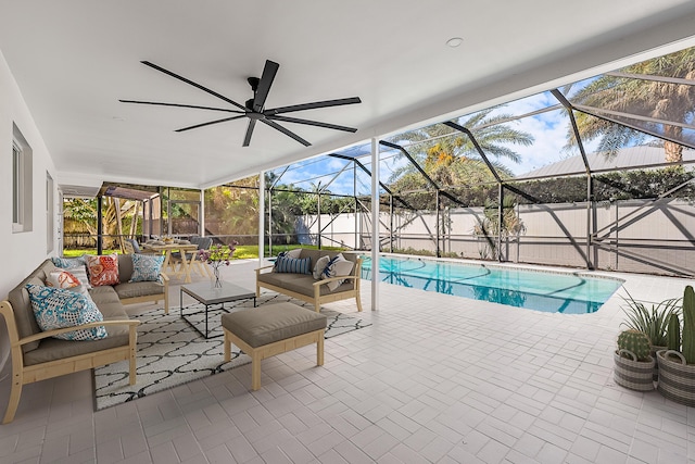 view of pool with a patio, glass enclosure, and an outdoor living space