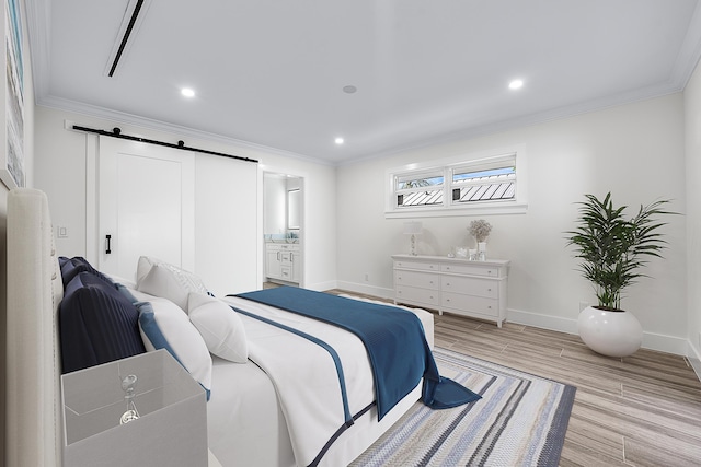 bedroom with a barn door, baseboards, crown molding, light wood-style floors, and recessed lighting