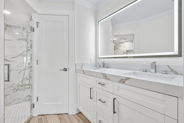 full bathroom featuring crown molding, a marble finish shower, and a sink