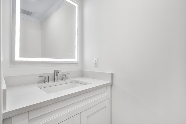 bathroom with visible vents, crown molding, and vanity