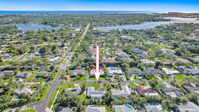 drone / aerial view with a water view and a residential view