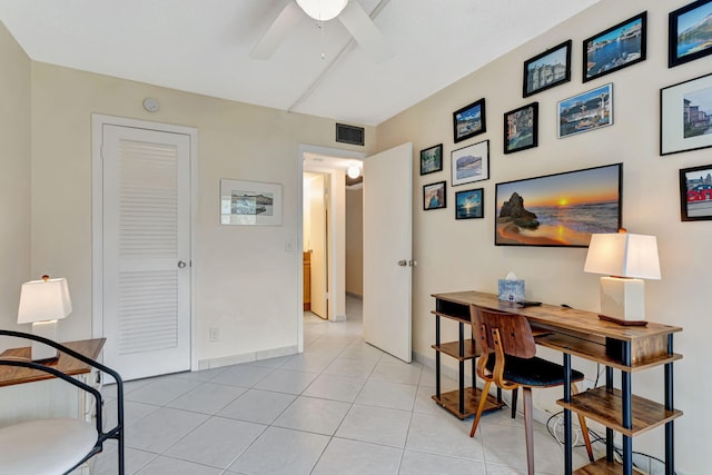 office space featuring light tile patterned floors, ceiling fan, visible vents, and baseboards