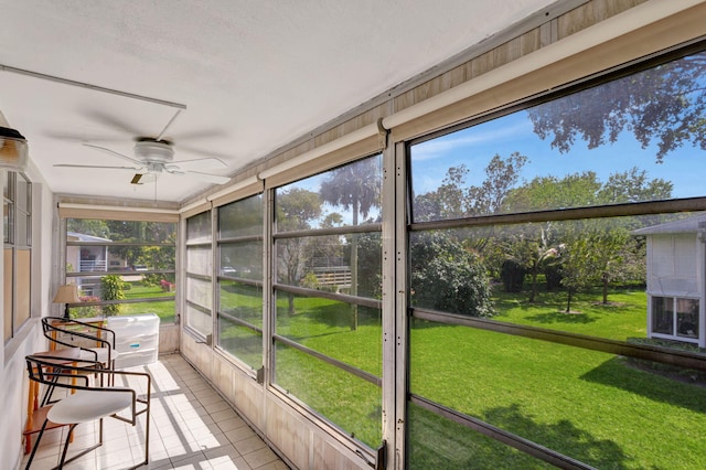 unfurnished sunroom with a ceiling fan