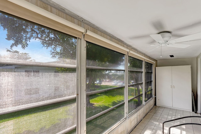 unfurnished sunroom with a ceiling fan