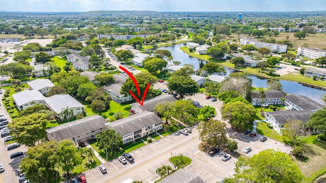 birds eye view of property with a residential view and a water view