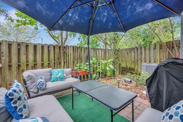 view of patio / terrace featuring a fenced backyard, an outdoor living space, and central air condition unit