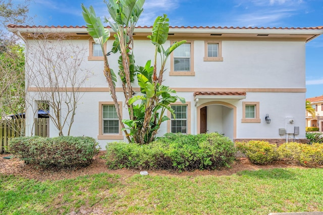 view of front of home with a tile roof and stucco siding