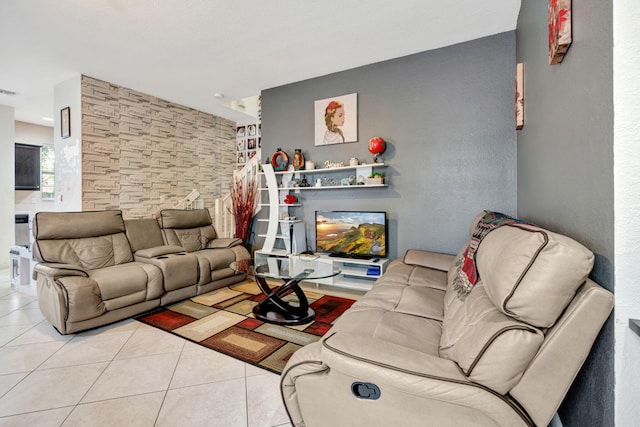 living area with an accent wall, light tile patterned flooring, and visible vents