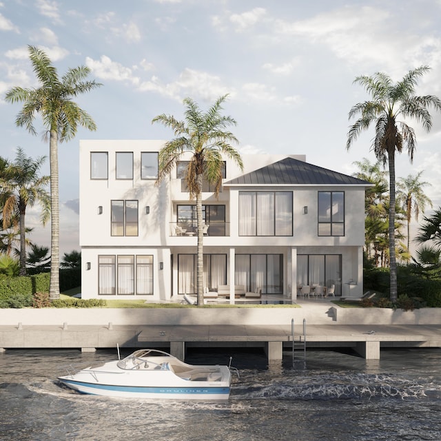 748 NE 72nd St, Boca Raton, FL 33487 - rear view of house with a standing seam roof, stucco siding, and a metal roof
