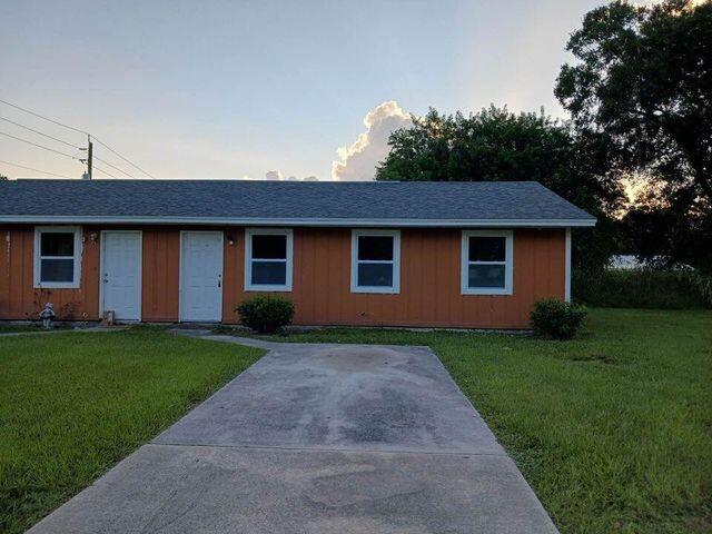 ranch-style house with a front lawn